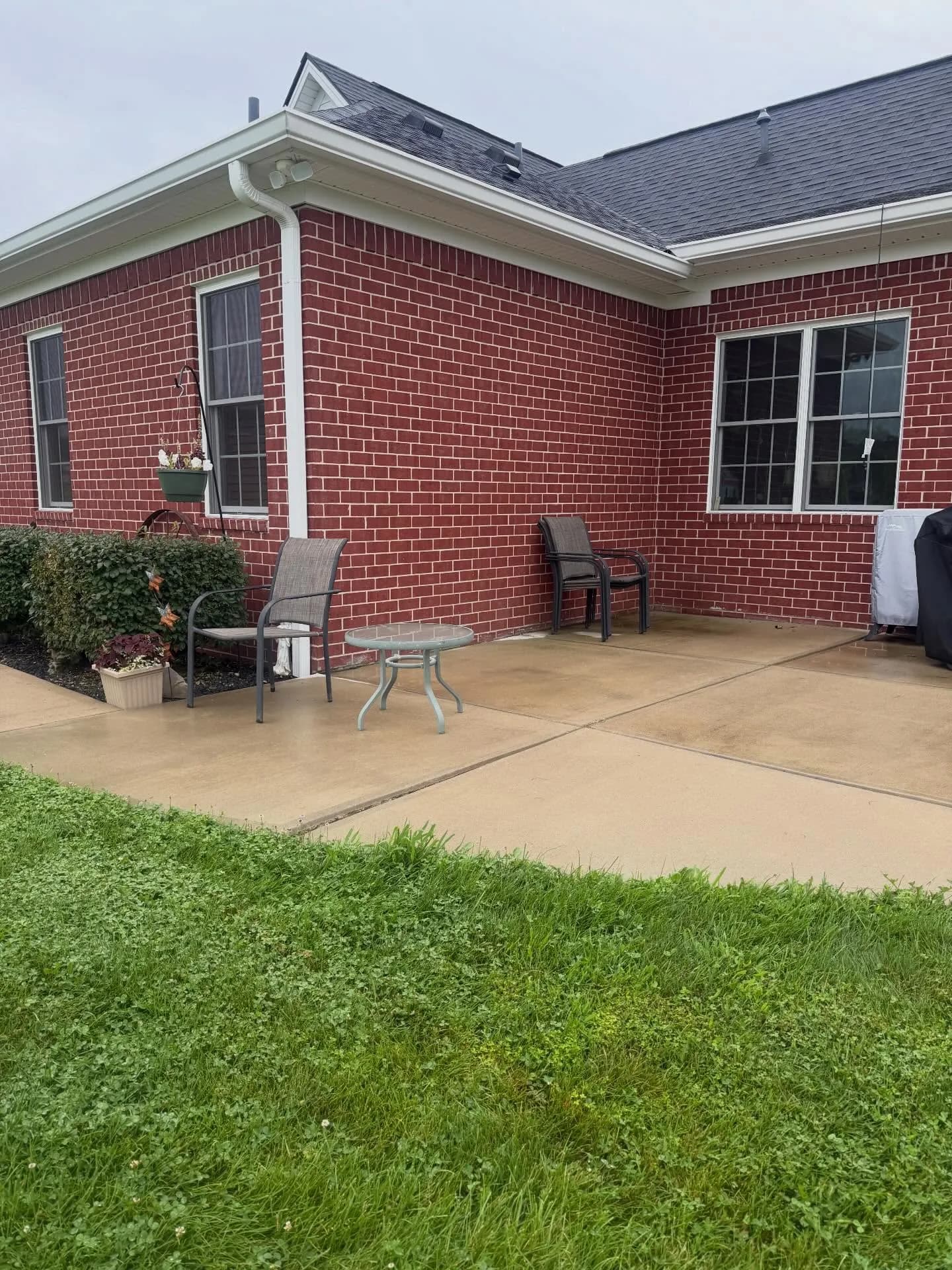 Light-gray stamped patio with matching walkway and step