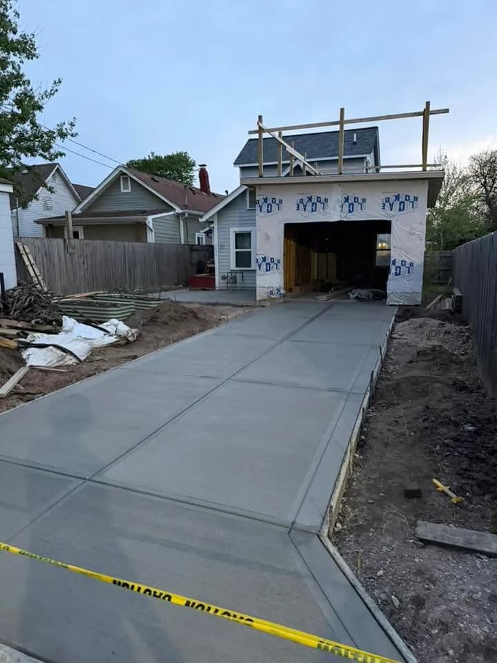 Residential concrete driveway leading to a garage