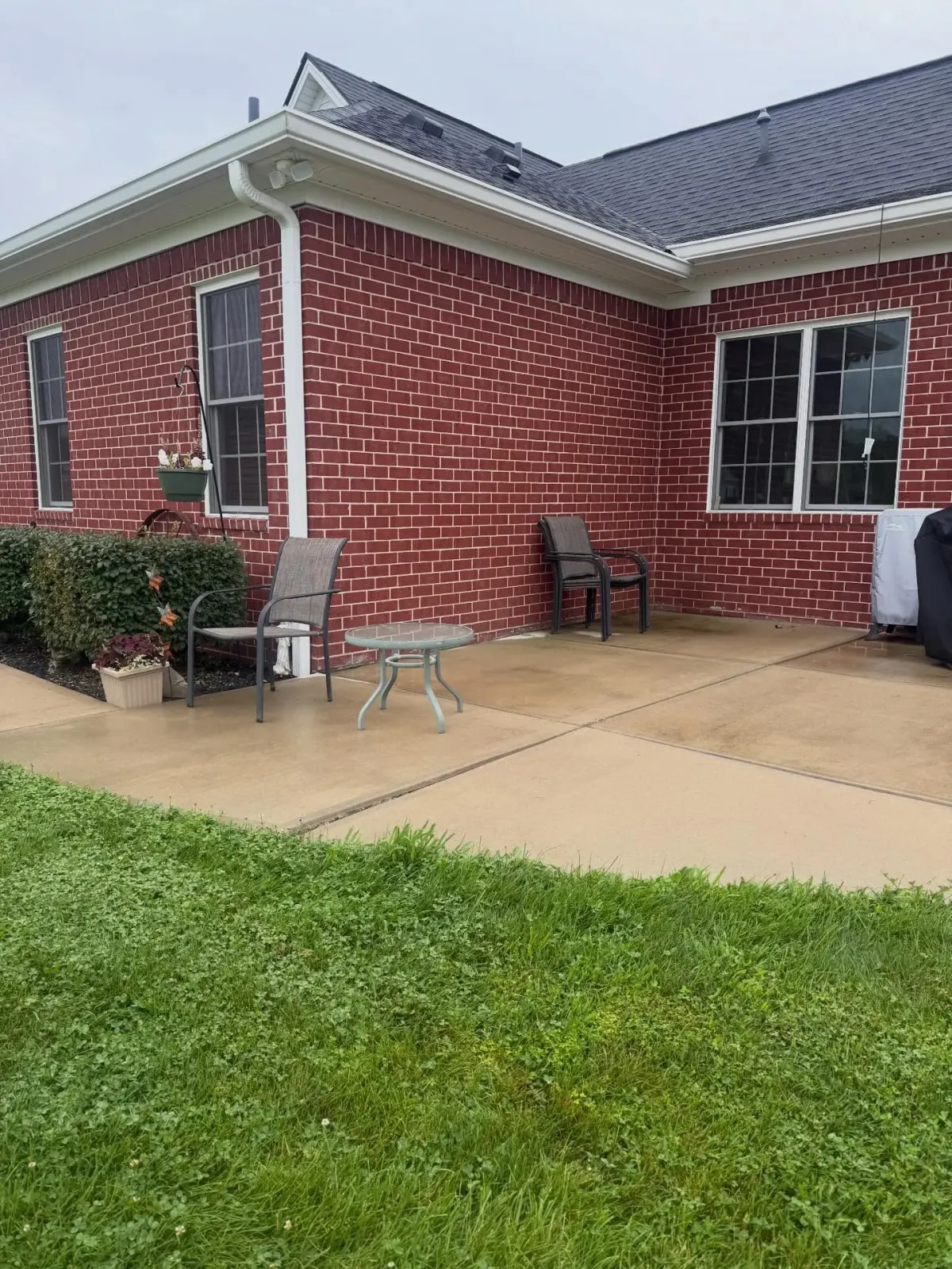 Light-gray stamped patio with matching walkway and step
