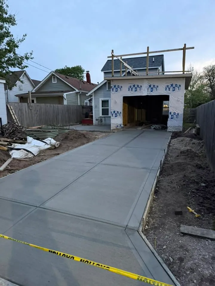 Residential concrete driveway leading to a garage